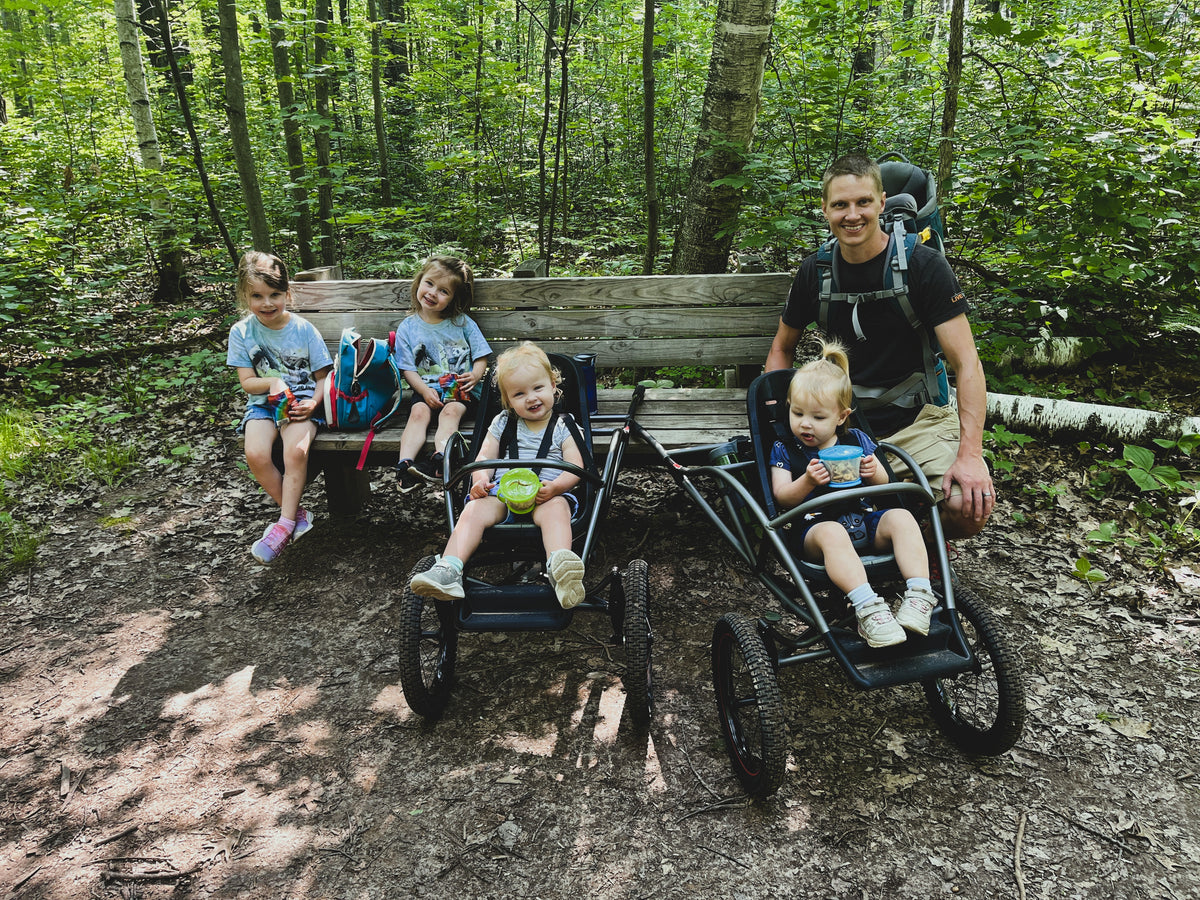 The founder and his four children field-testing early Bera Buggy prototypes on a Minnesota forest trail
